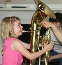 Young girl tries tuba