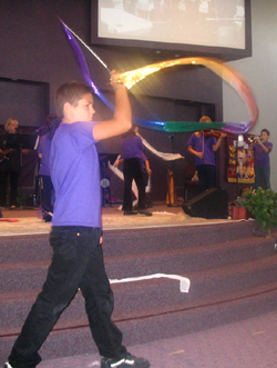 Child uses flags for worship