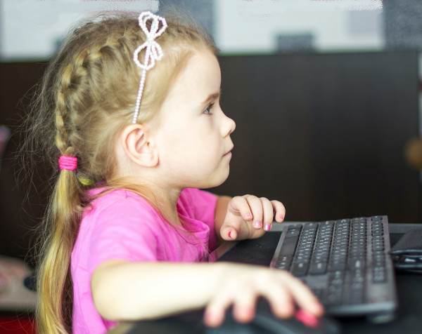 Young girl uses computer