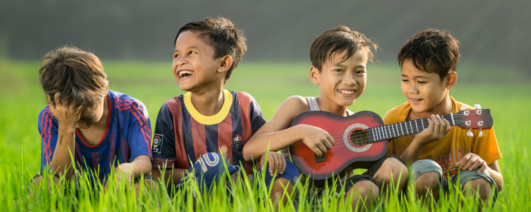 Group of boys play guitar 