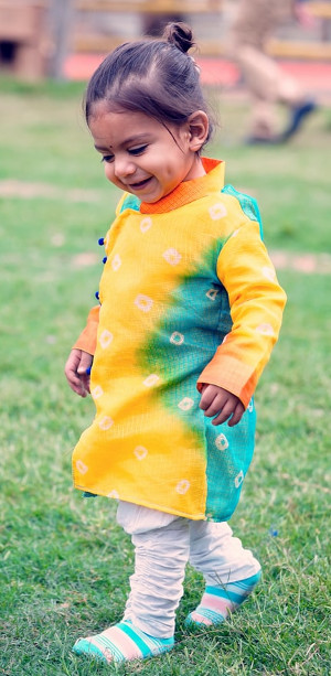 Toddler girl in grass